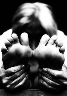 Image of a person holding his feet