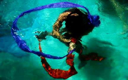 A girl dancing in water with two bands